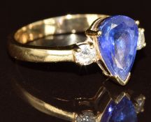 A 14k gold ring set with a pear cut tanzanite of approximately 1.25ct and two round cut diamonds