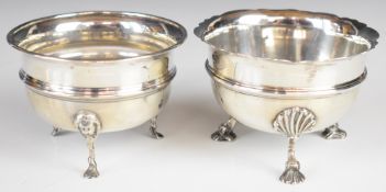 Two George V hallmarked silver sugar bowls, each raised on three feet, one with lion mask and paw