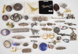 A collection of c1900 silver brooches including 'Mabel', 'Emily', 'Annie' and 'Carrie', military