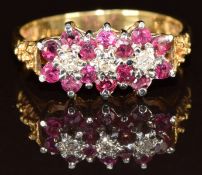 An 18ct gold ring set with diamonds and rubies in three clusters, 3.4g, size L
