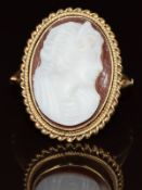 A 9ct gold ring set with an agate cameo depicting a young woman, 4g, size O