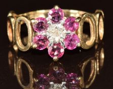 A 9ct gold ring set with a diamond and rubies in a flower cluster, 2g, size M