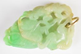 Chinese carved jadeite pendant featuring a monkey, fruit and foliage, 50mm long.