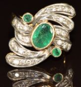 An 18ct gold ring set with an oval cut emerald of approximately 1.5ct, two round cut emeralds of