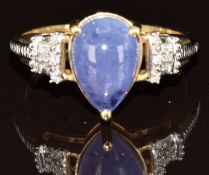 A 9ct gold ring set with a pear cut tanzanite cabochon and diamonds, 2.8g, size N