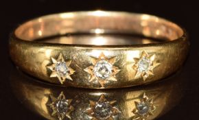 A 9ct gold ring set with three diamonds in a star setting, 3.9g, size U