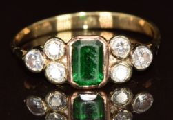 An 18ct gold ring set with an emerald cut emerald of approximately 0.5ct and six round diamonds, 1.