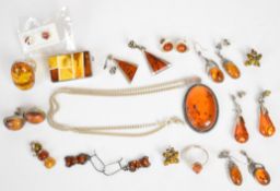 A collection of silver jewellery set with pressed amber including nine pairs of earrings, two rings,