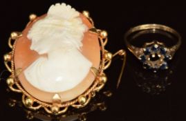 A 9ct gold ring set with sapphires (missing centre stone, 1.6g) and a rolled gold brooch set with