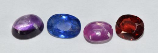 Four loose gemstones including oval amethyst cabochon (1.3ct), oval cut garnet (1.2ct), star ruby
