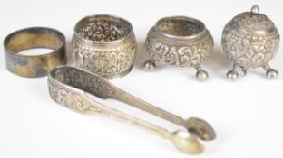 Indian Kutch silver pepper, salt, napkin ring and sugar tongs together with a hallmarked silver