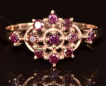 A 9ct gold ring set with purple diamonds in a cluster, 2.2g, size Q
