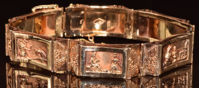 An 18k gold Peruvian bracelet made up of six rectangular panels, each depicting a different scene,