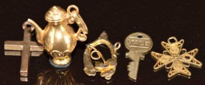 An 18k gold charm in the form of a coffee pot (1.3g), yellow metal filigree Maltese cross (0.4g),