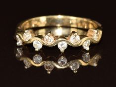 A 9ct gold ring set with diamonds in a wave setting, 1.9g, size L
