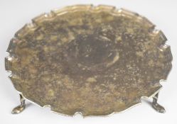 George V hallmarked silver salver with shaped edge, raised on four feet, London 1930, maker Jay,
