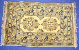 Afghan rug with two central guls and multiple geometric borders on a mustard ground, 230 x 114cm