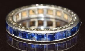 Art Deco white metal eternity ring set with twenty-two calibre cut sapphires, each approximately 0.