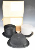 Three Lock and Co bowler and top hats including a silk covered example, the top hats boxed and a