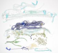 A collection of beads including sapphire, tanzanite, aquamarine and emerald