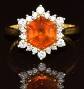 An 18ct gold ring set with an hexagonal citrine surrounded by diamonds, 4.4g, size O