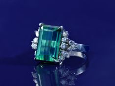 An 18k white gold ring set with a tourmaline of approximately 12.8ct and round and marquise cut