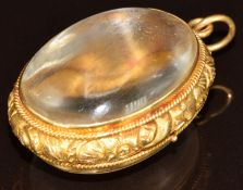 Georgian / Victorian locket with yellow metal embossed border and two domed glass cabochons, 14.