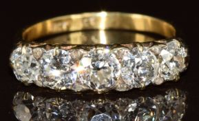 A c1900 18ct gold ring set with five old cut diamonds of approximately 0.6, 0.5, 0.5, 0.4 & 0.4ct
