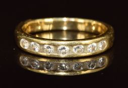 An 18ct gold ring set with seven round cut diamonds, 3.3g, size K