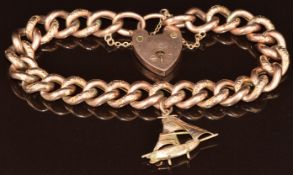 A 9ct rose gold curb link bracelet with alternating engraved links and heart padlock clasp, and a