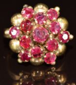 A 15k gold ring set with rubies in a star cluster setting, 5g, size P