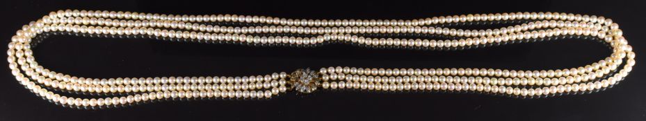 A triple strand cultured pearl necklace, the 14k gold clasp set with diamonds, 57g, 70cm