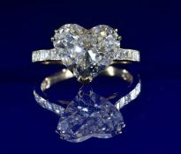 An 18ct gold ring set with a heart cut diamond of approximately 3.62ct and with further Asscher