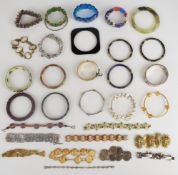 A collection of bangles and bracelets including gold plated buckle bangle, beaded garnet, cameo,