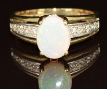 A 9ct gold ring set with an oval cut opal and diamonds, 2.8g, size N