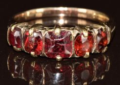 A 9ct gold ring set with five garnets, 2.4g, size O
