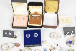 Over 100 pairs of silver earrings including pressed amber, knots, amethyst, turquoise, filigree,