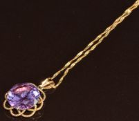 A 14k gold pendant set with a synthetic purple sapphire (4.6g) and 9k gold chain (0.7g, damaged)