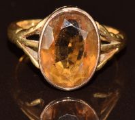 An 18ct and 9ct gold ring set with an oval cut smoky quartz, 5.3g, size O