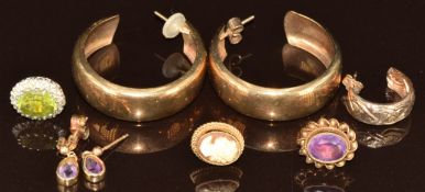 A pair of 9ct gold hoops, pair of 9ct gold earrings set with amethysts, three single 9ct gold
