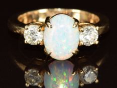 A 14k gold ring set with a synthetic opal and two diamonds, each approximately 0.2ct, 4.4g, size K