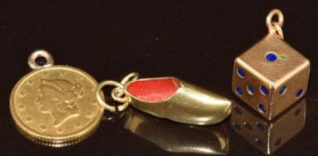 A yellow metal charm / pendant in the form of a dice marked 800 (1.2g), a yellow metal shoe charm (