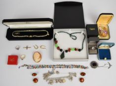 A collection of jewellery including silver charm bracelet with sixteen silver charms, paste