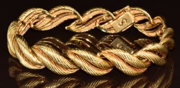 An 18ct gold bracelet made up of ridged wave shaped links, 46.2g, 19cm
