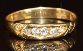 An 18ct gold ring set with five old cut diamonds, 1.8g, size Q