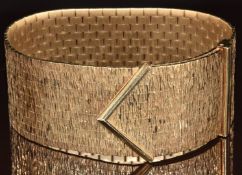 A 1970's 9ct gold bracelet made up of textured rectangular links, maker RCK, 80.6g, 18cm