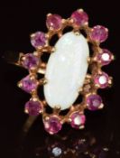 A 9ct gold ring set with on opal surrounded by round cut spinels, each approximately 0.06ct, 4.8g,