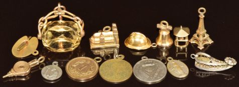 A 9ct gold swivel fob set with paste, six yellow metal charms and other charms