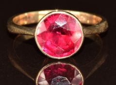 A 9ct gold ring set with a round cut synthetic ruby, 2.3g, size J