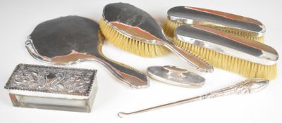 Hallmarked silver mounted dressing table items including hand mirror, three brushes and a